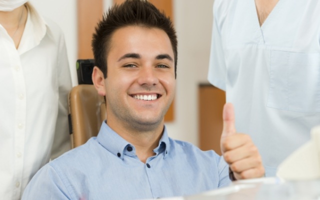 Smiling man giving thumbs up after amalgam free dentistry