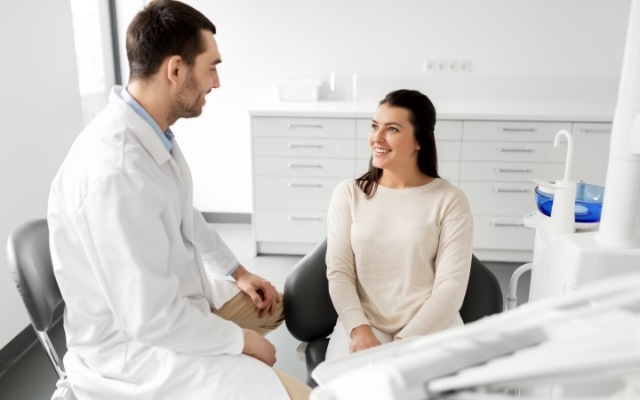 Dentist talking to dental patient