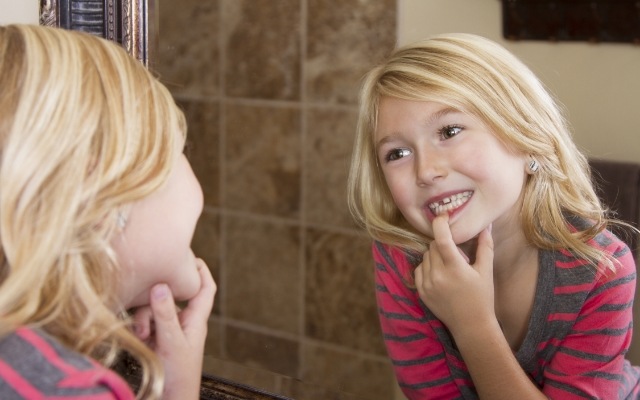 Child looking at smile in the mirror
