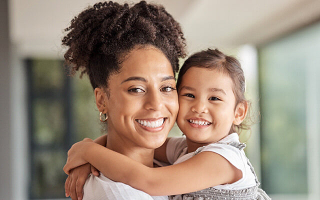 a mother showing off her whiter smile after teeth whitening in chaska