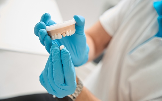 Dentist showing patient how a dental crown is placed