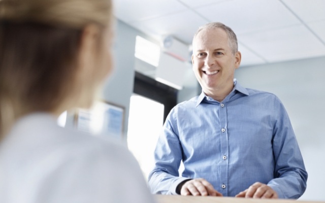 Man checking in at dental office