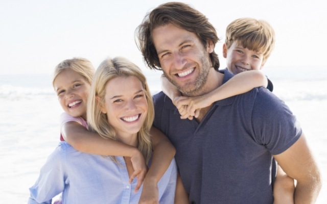 Family smiling after dental cleaning visit