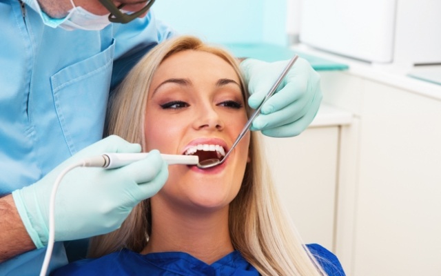 Dentist capturing smile images using intraoral camera