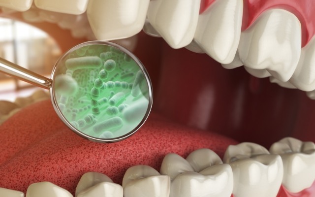 Animated smile with enlarged bacteria that cause halitosis