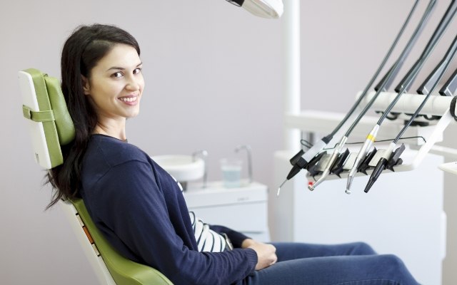 Woman smiling during preventive dentistry checkup and teeth cleaning visit