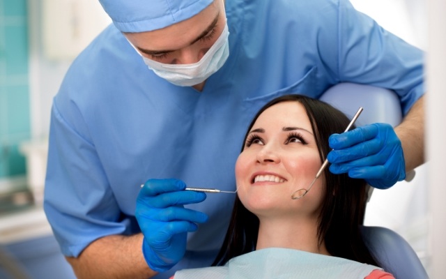 Woman smiling during oral cancer screening