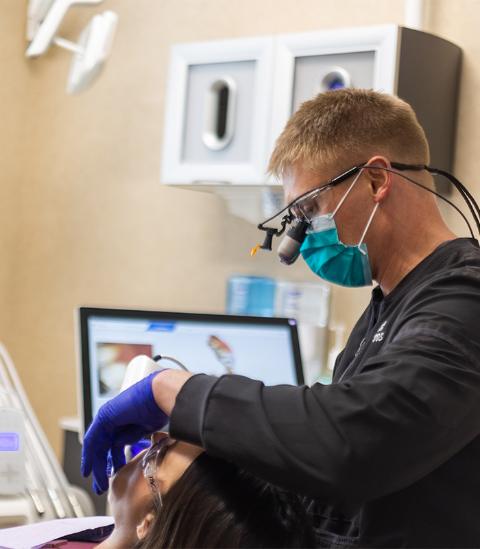 Chaska dentist wearing dental binoculars while treating a patient