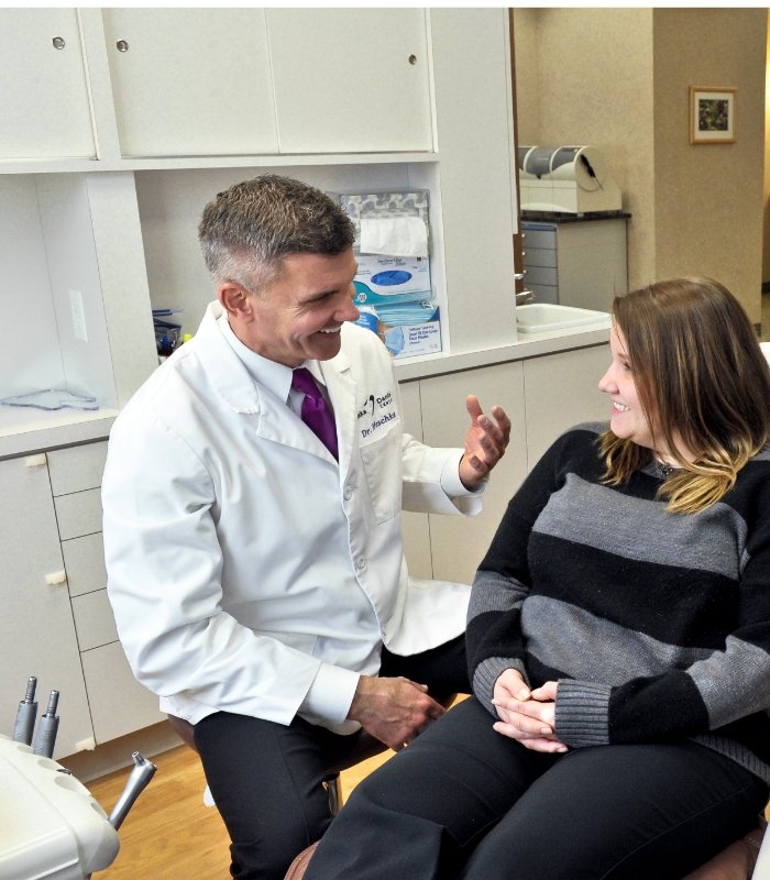 Chaska Minnesota dentist talking to woman in dental chair