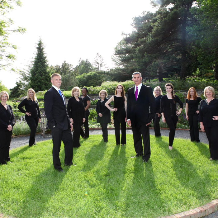 Chaska dentists and dental team standing outdoors in black clothing