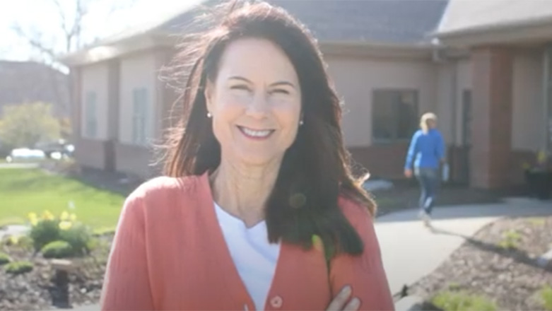Smiling woman standing in the sun