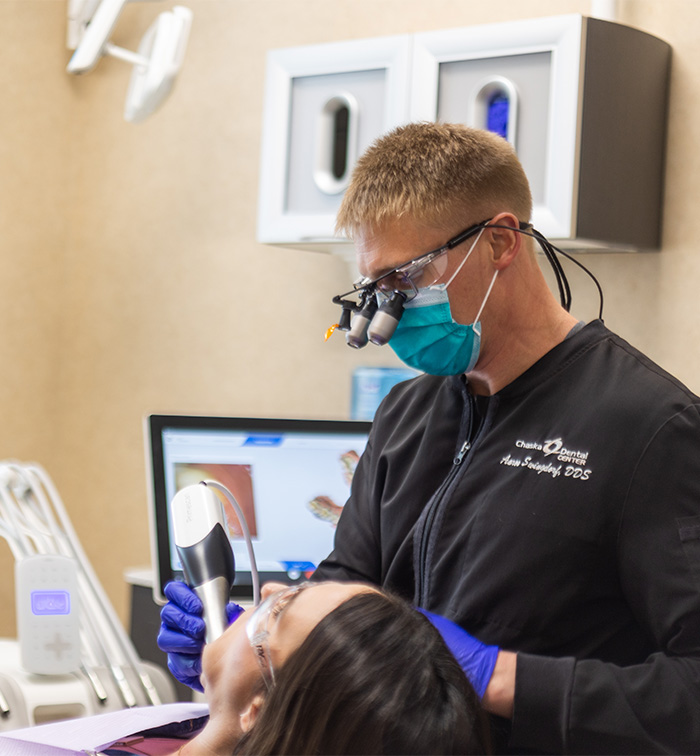 Chaska dentist wearing dental binoculars while treating a patient