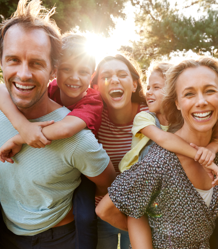 Family of five smiling outdoors