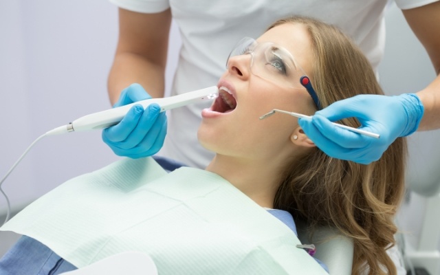 Dentist using intraoral camera to capture smile images