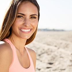 Young woman on the beach and smiling