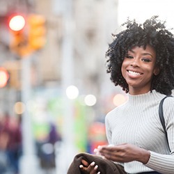 Girl walking in the city showing off her smile