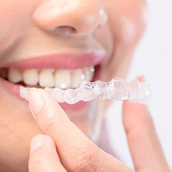 Patient inserting an Invisalign aligner