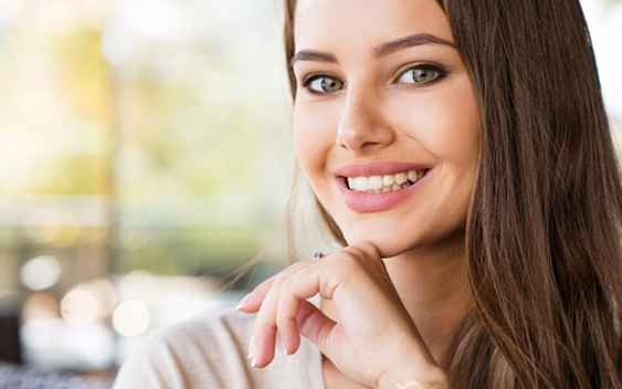 Young woman showing off her straighter smile after Invisalign in Chaska 