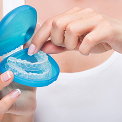 An Invisalign aligner in a protective case 