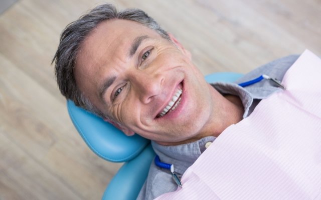 Man smiling during oral cancer screening