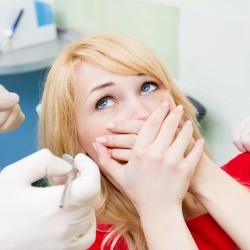 Woman hiding smile before Invisalign treatment