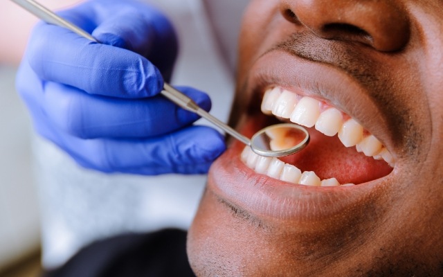 Dentist examining smile after gum disease treatment