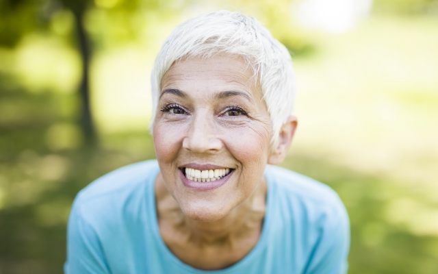 Older woman smiling after senior dentistry visit