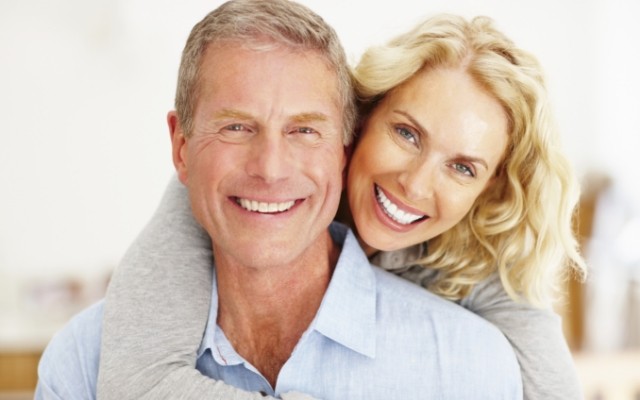 Older man and woman smiling after senior dentistry visit