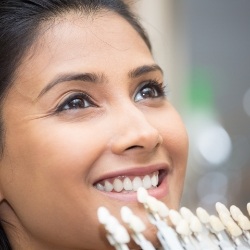 Woman's smile compared with veneer color options