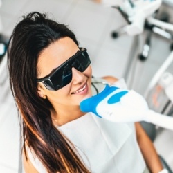 Woman receiving professional teeth whitening