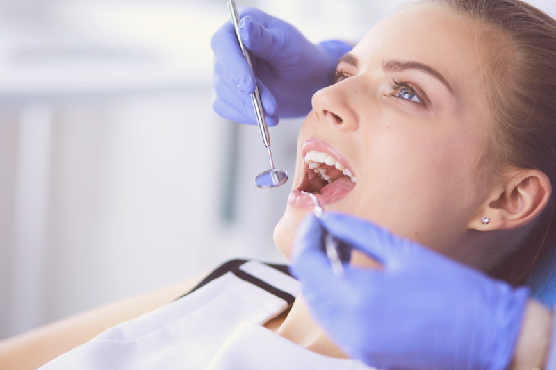 woman having dental work performed in office