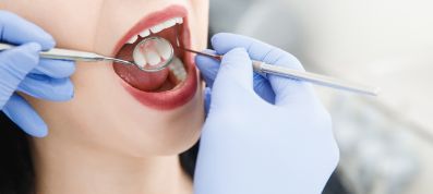 Dentist performing an exam on female patient