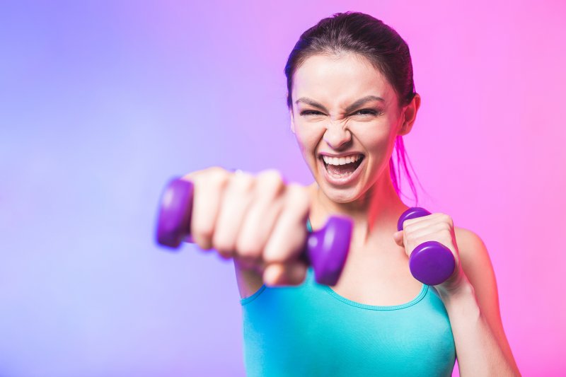 young woman working out with hand weights