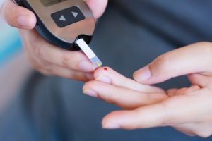 woman measuring blood sugar