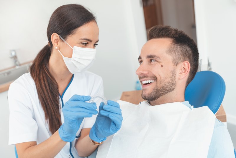 Dentist talking to male patient about Invisalign 