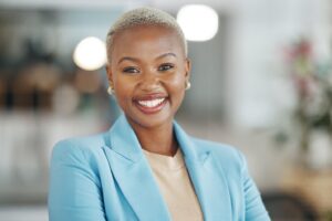 younger woman in a blue blazer smiling